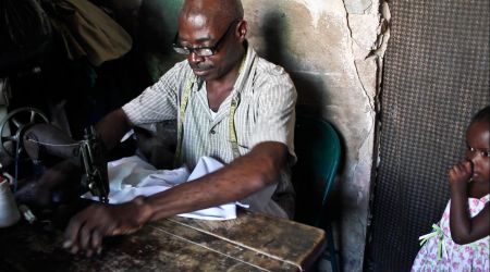 Daomed Daniel, a Haitian tailor in Cité Soleil, can no longer find full-time work because of the unregulated dumping of used clothing, which he says is "invading the country." Photo by Isabeau Doucet