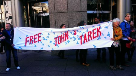 Banner at Montreal protest demanding freedom for Tarek Loubani and John Greyson. Photo by Tim McSorley