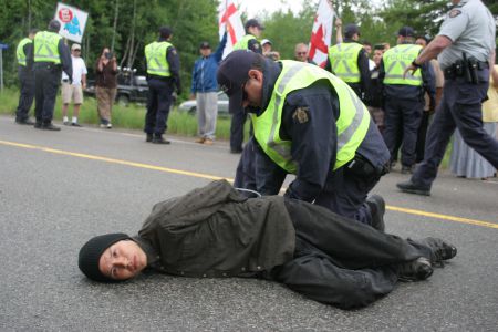 Segewa't Na'gu'set, one of the fire keepers at the sacred fire encampment, was among 12 people arrested at a peaceful protest along highway 126 on June 21st, National Aboriginal Day. Photo by Miles Howe