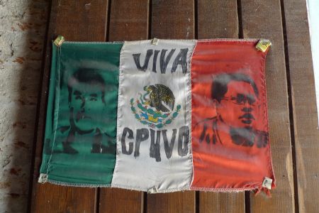A Mexican flag reads "Long Live CPUVO" and bears the portraits of Bernardo Méndez and Bernardo Vásquez, the two anti-mine activists who were killed in early 2012. Photo by Sara Méndez